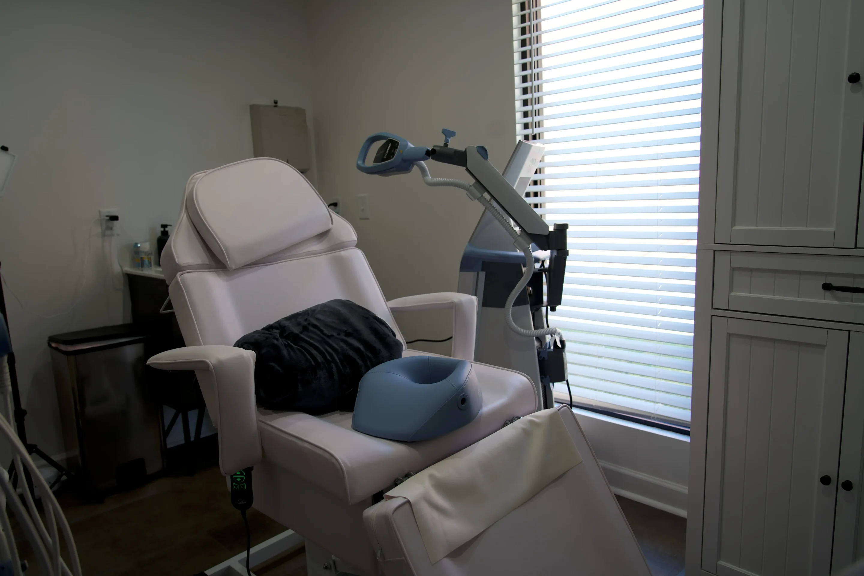 Adult client seated comfortably during a TMS therapy session with Exomind at Williamson Aesthetics & Wellness in Franklin, TN