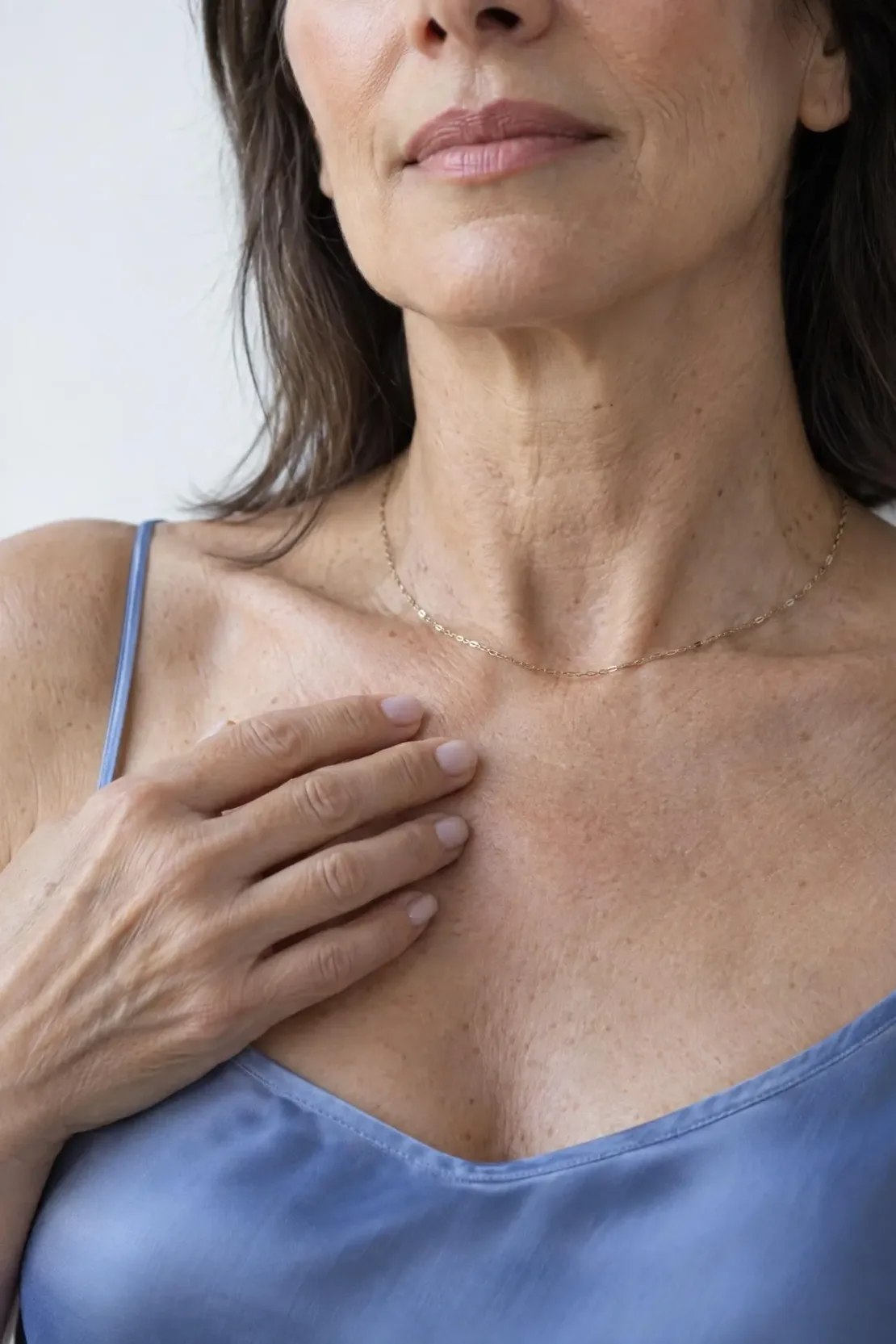 Close view of mild cheek and jawline laxity on adult skin, a common sign of sagging skin reviewed in Franklin, TN